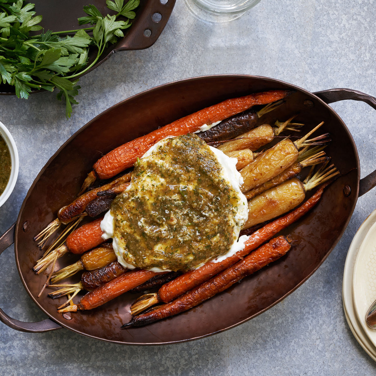 Roasted carrots topped with herb sauce in an Oval Roaster