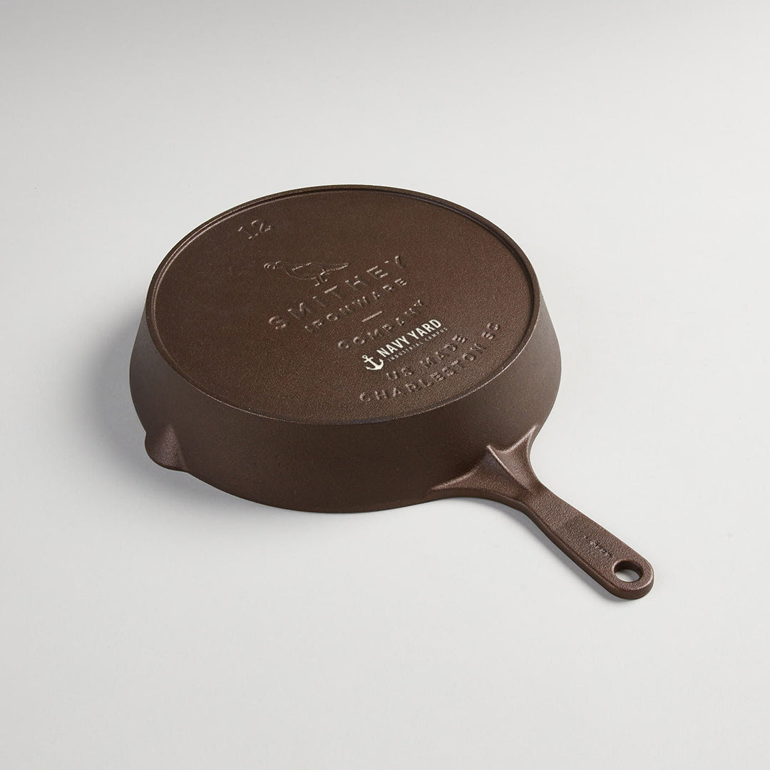 A client logo engraved into the base of a No. 12 cast iron skillet