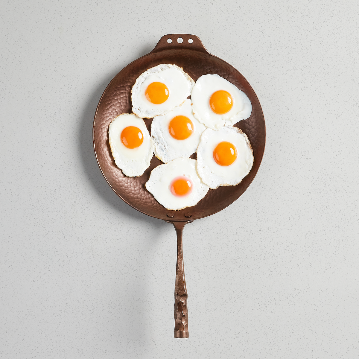 Fried eggs filling a Farmhouse Skillet, viewed from above